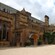 The gravel entrance to a 17th century stone manor surrounded by gardens